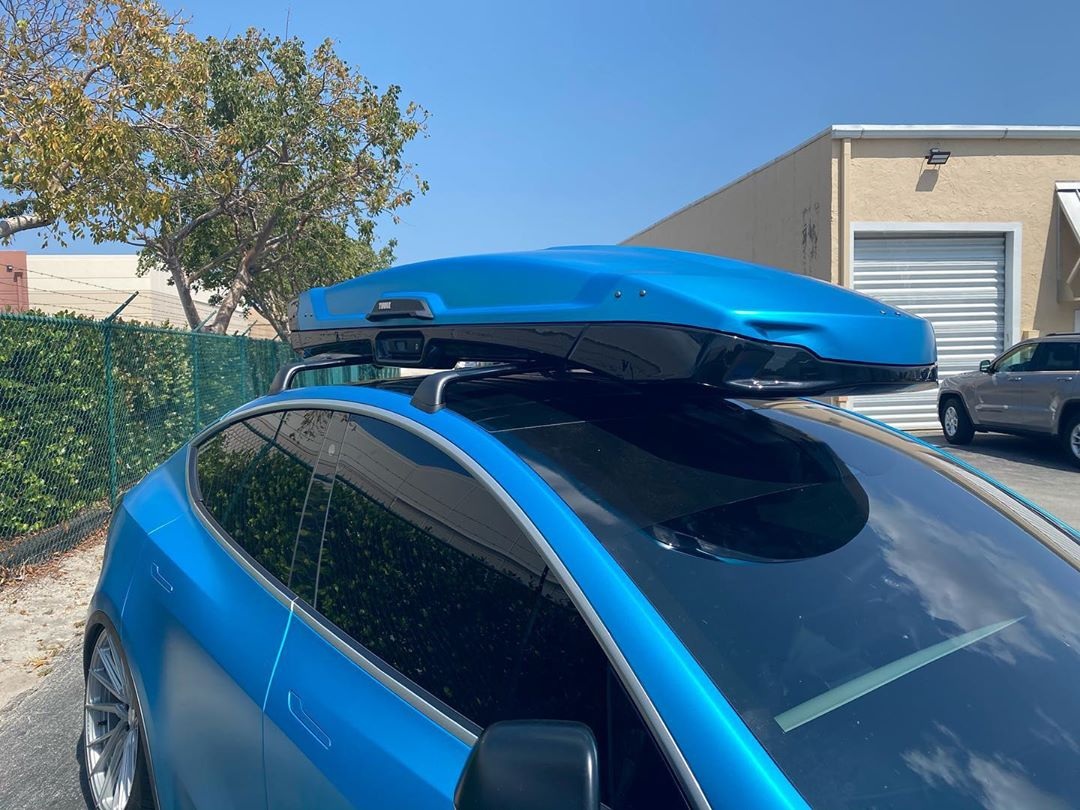 This custom wrapped Tesla Model Y with the roof racks and matching