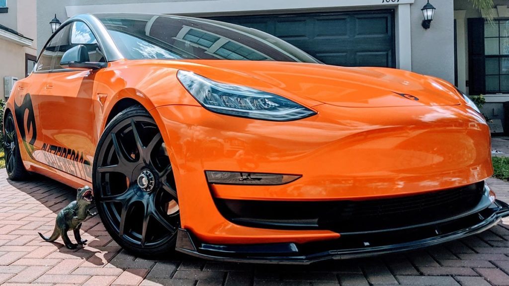 Orange wrapped Tesla Model 3.