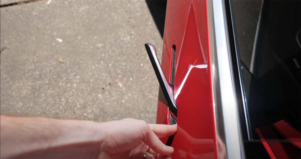Opening the Tesla Model 3 door handle
