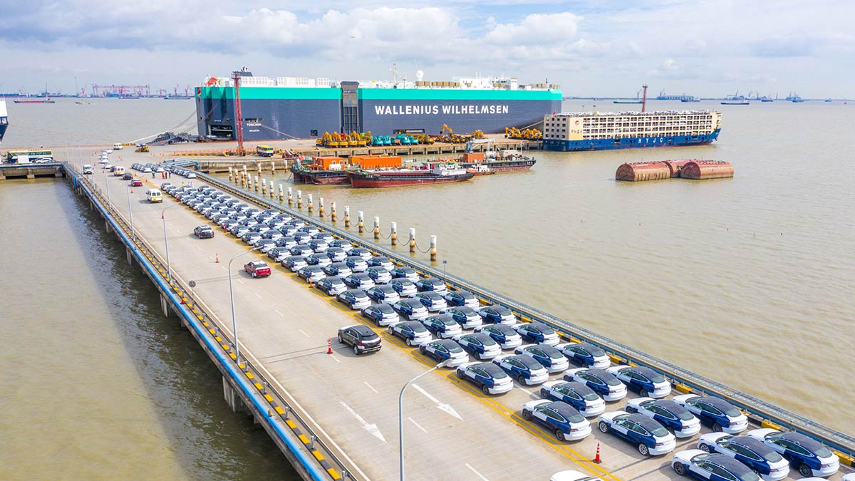 A fleet of Made-in-China Tesla Model 3 cars at the Port of Shanghai waiting to be loaded on the vehicle transport vessel named Toscana by Wallenius Wilhemsen.