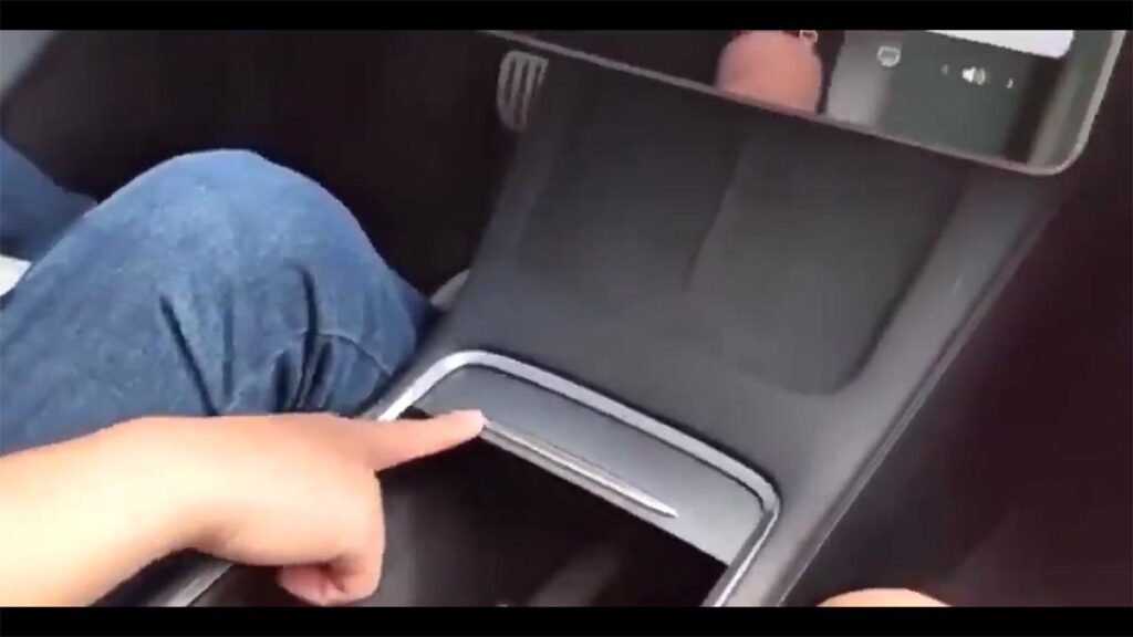 Tesla Model 3 center console slides open and close (video).