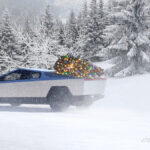 Tesla Cybertruck in snow with Christmas gifts.