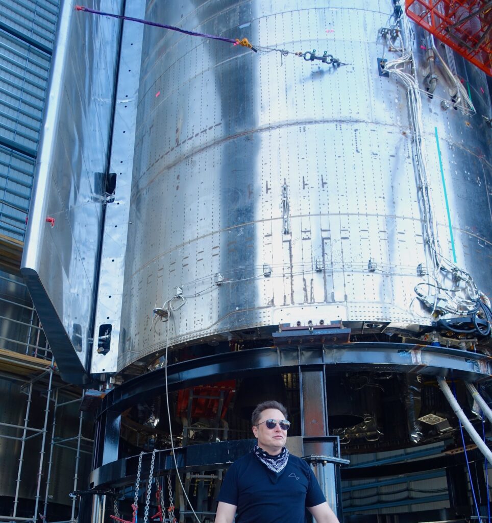 Elon Musk poses under the Starship SN9 in Boca Chica, Texas.