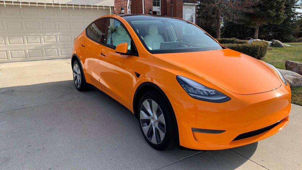 Orange wrapped Tesla Model Y electric SUV (cost, service provider, photo gallery).