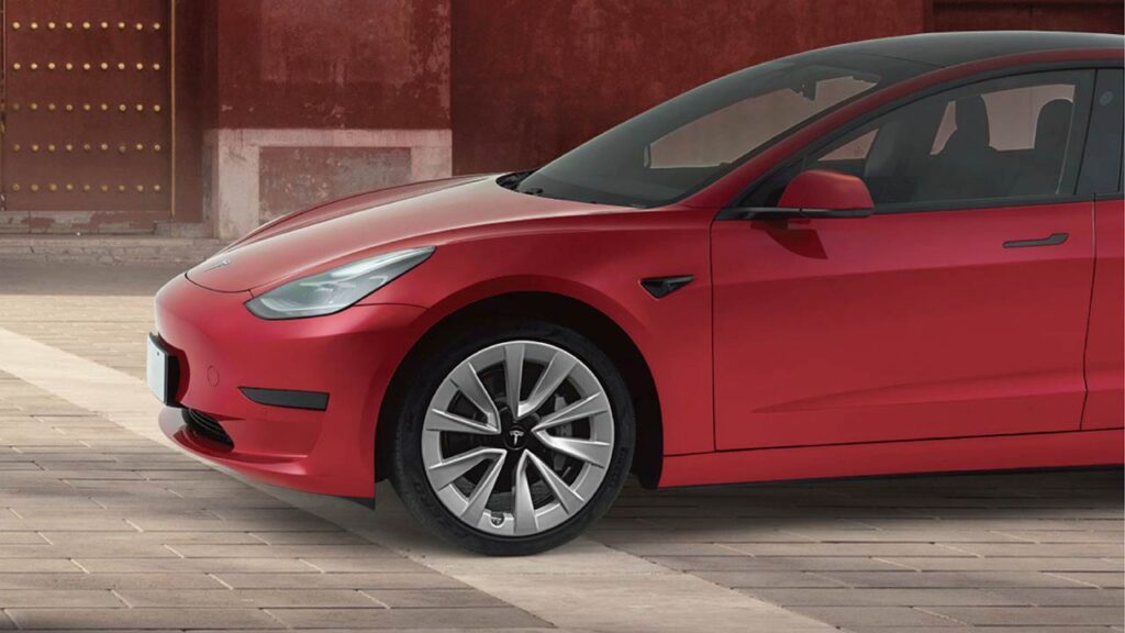 Tesla Model 3 in red color (closeup shot).
