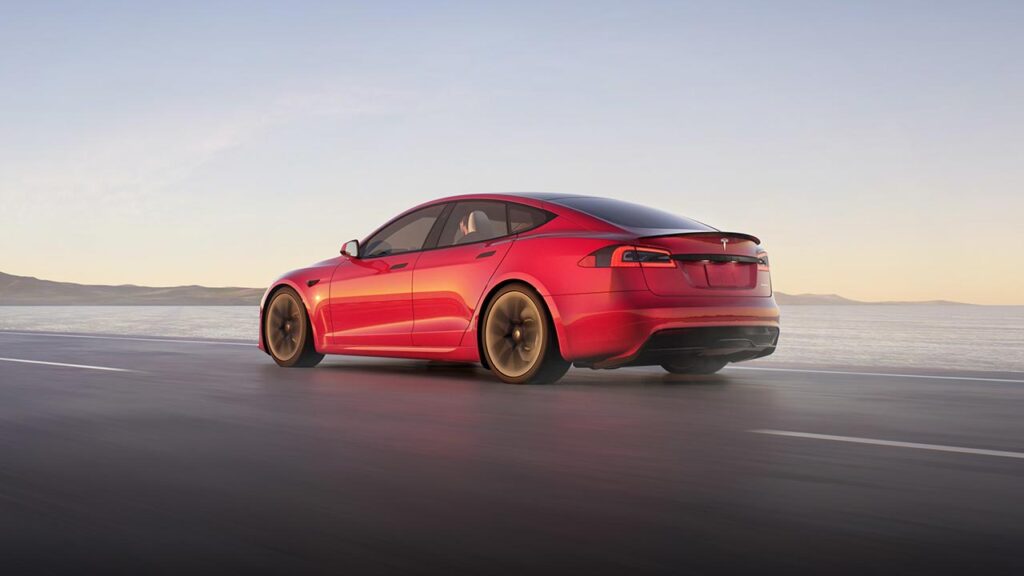 2021 Tesla Model S in red color (rear side profile view).