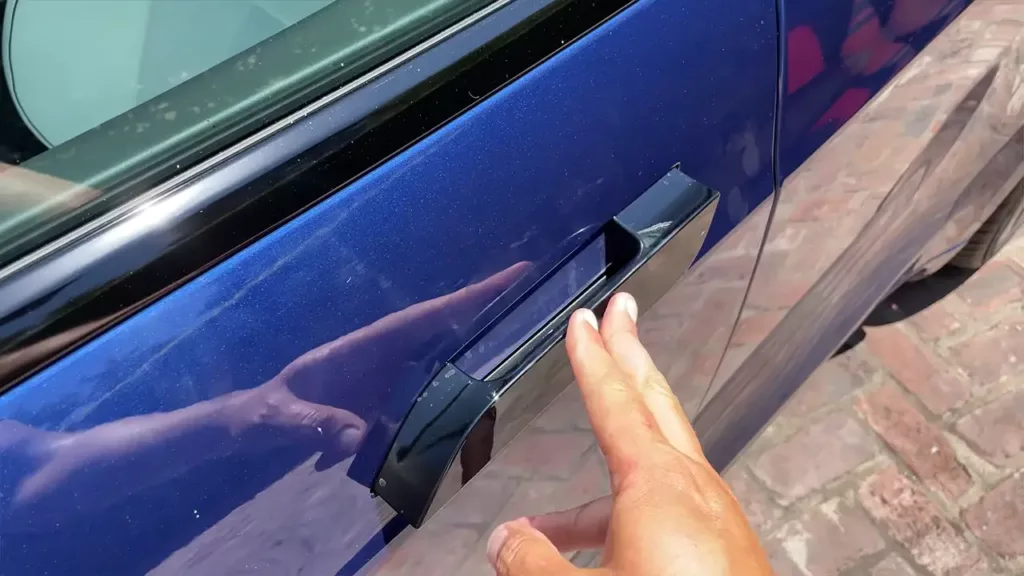 Push the 2021 Model S popped-out door handle slightly if it is stuck and the door won't open from the outside.