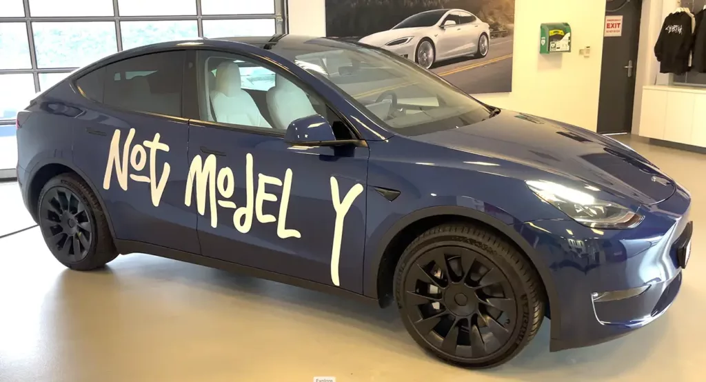 Tesla Model Y with the "Not Model Y" meme-sticker in a Tesla Store in Belgium.