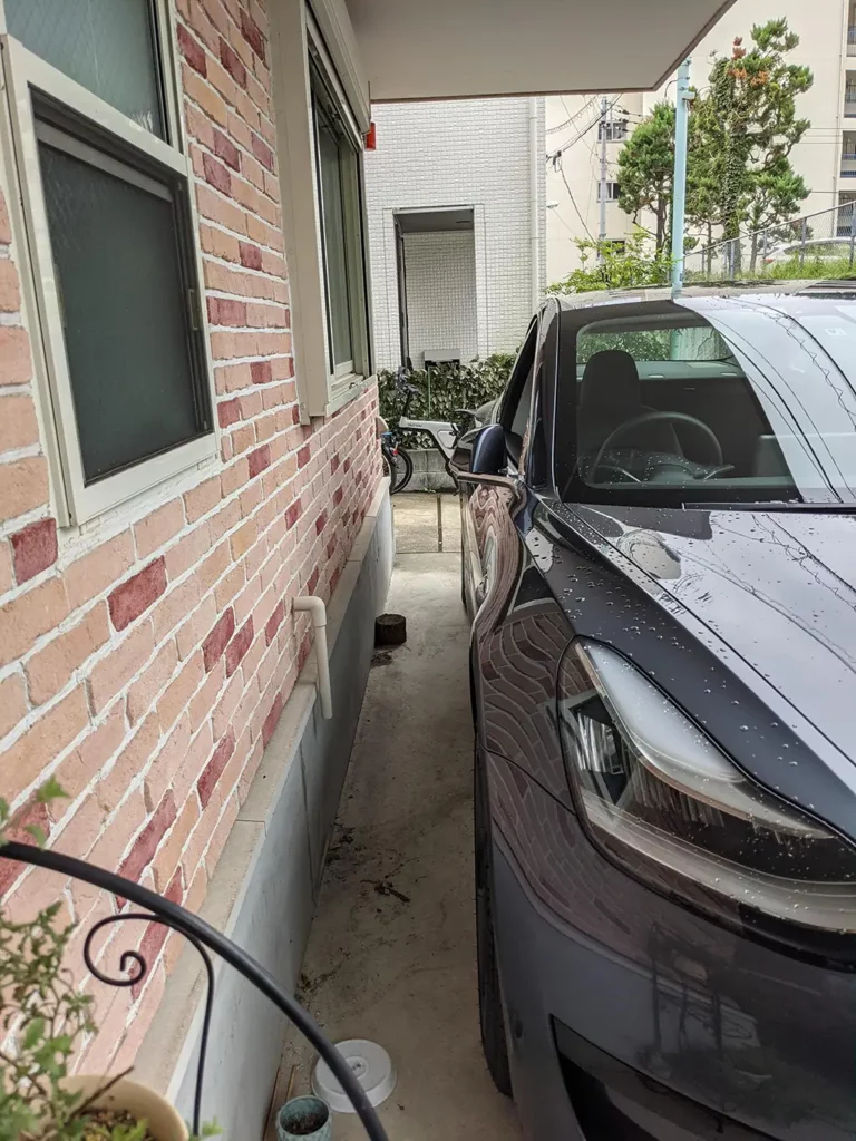 Tesla Model 3 tightly parked at a house in Tokyo, Japan.