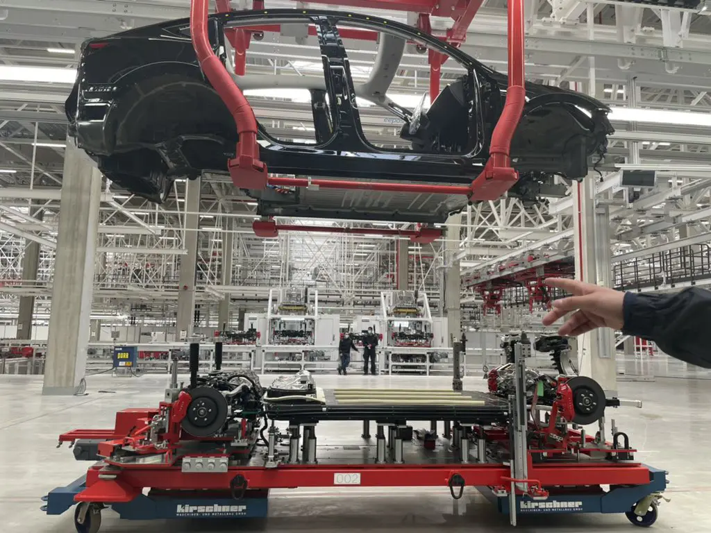 Tesla demonstrating how the new structural battery will be mated to the body frame to act as a floor at Giga Berlin Giga-Fest.