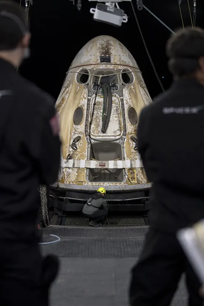 Support teams work around the SpaceX Crew Dragon Endeavour spacecraft shortly after it landed with the NASA astronauts.