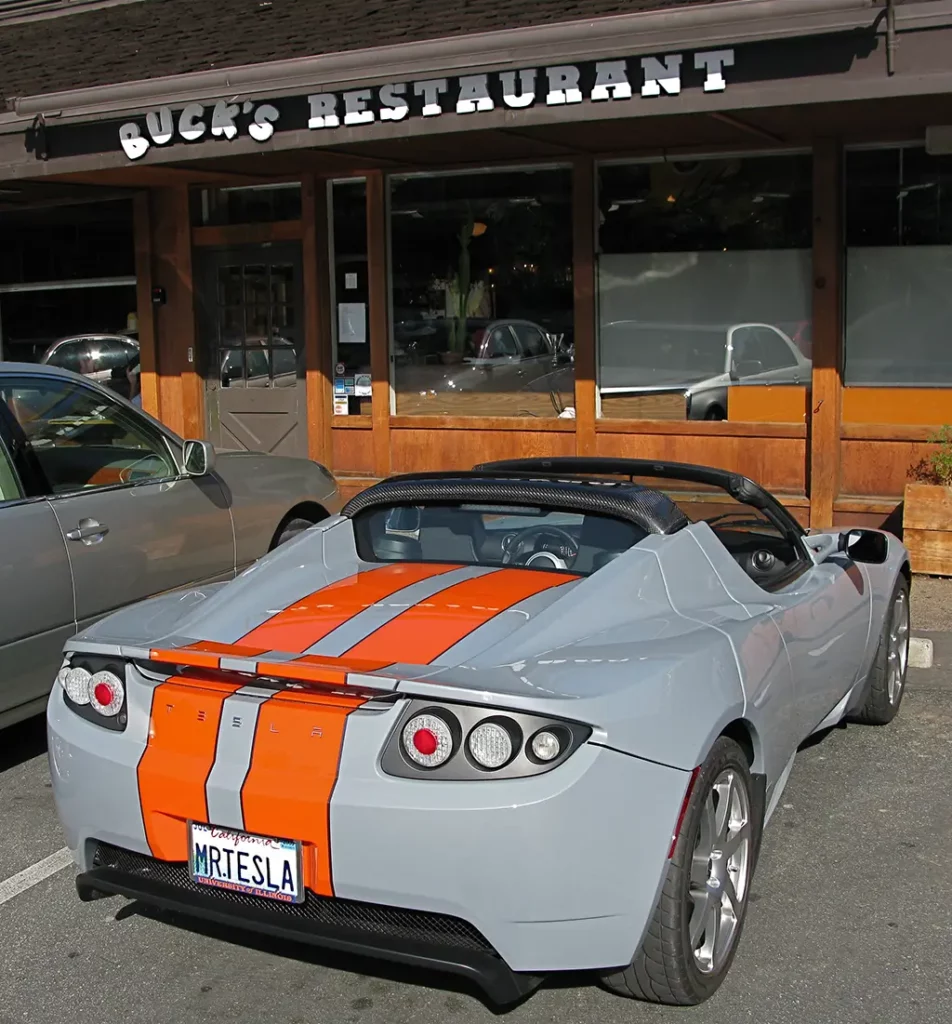 Martin Eberhard's original Tesla Roadster VIN #2. Custom light gray color with red sport stripes across the middle of the car.