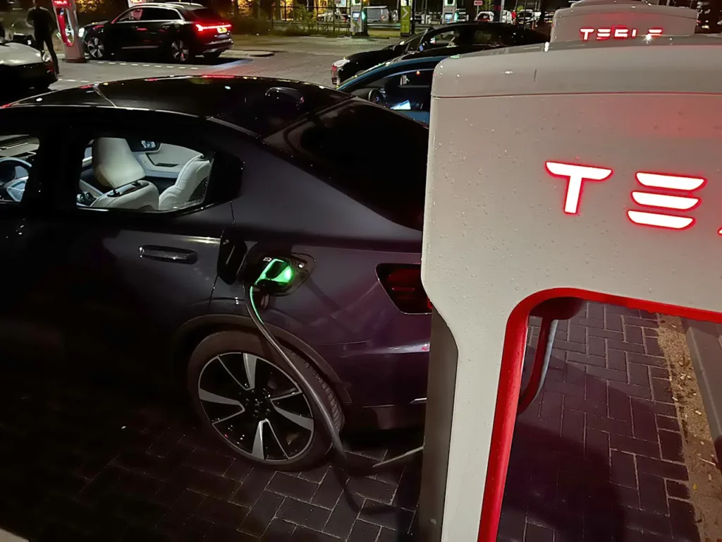 A Polestar 2 electric car charging at a Tesla Supercharger in the Netherlands.