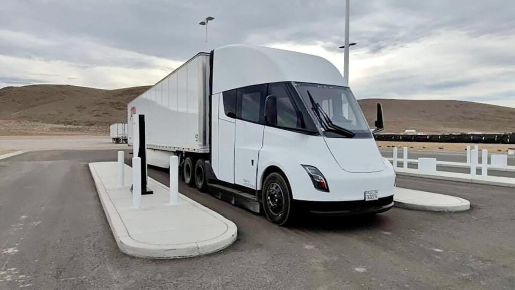A Tesla Semi Truck prototype in white color charging at the Megacharger station outside the Tesla Gigafactory Nevada.