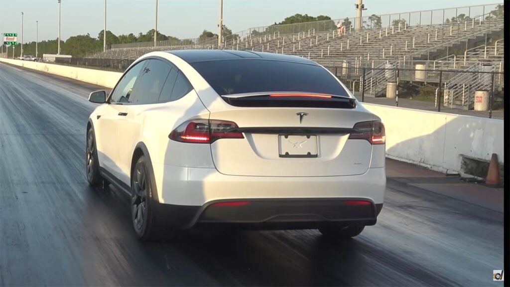 Tesla Model X Plaid at the start line of a dragstrip.