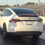 Tesla Model X Plaid at the start line of a dragstrip.