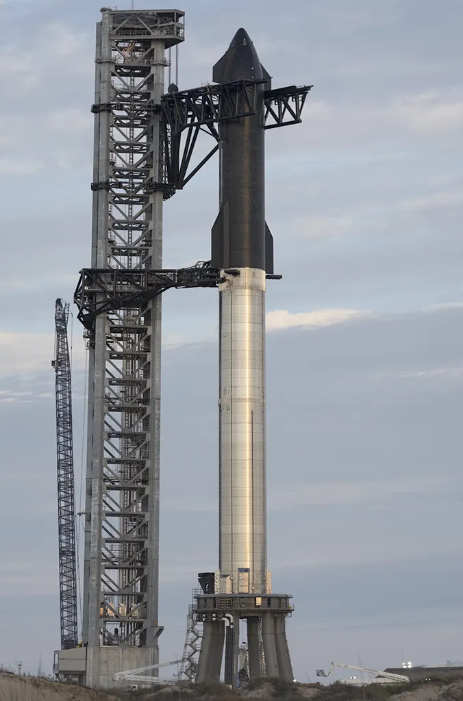 Fully stacked Starship SN20 prototype held by the launch tower (Mechazilla) chopsticks at SpaceX Starbase launch site in Boca Chica, Texas.