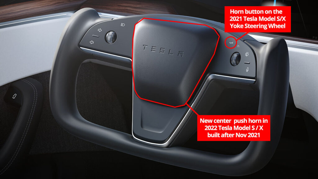 The yoke steering wheel of the 2021 Tesla Model S and Model X (both AWD and Plaid variants) with the labeled location of the old horn button and the new center push for 2022 models built after Nov 2021.