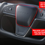 The 2021 Tesla Model S and Model X caliper steering wheel (AWD and Plaid variants) with the location labeled for the old horn button and new center thrust for 2022 models built after November 2021.