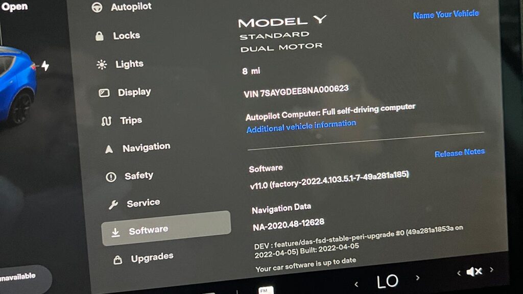 The center touchscreen of a Tesla Model Y Dual Motor Standard variant spotted showing vehicle information at Giga Texas during the Cyber Rodeo factory tour.