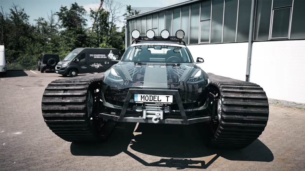 Tesla Model 3 converted to an off-road tank with chains instead of wheels.