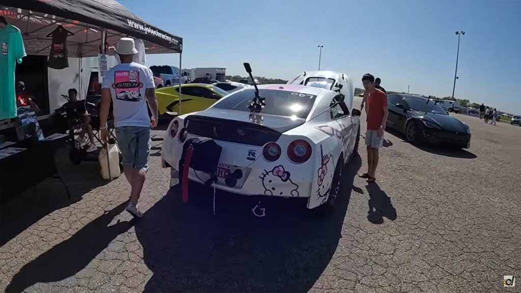 Modified 1,400 hp Nissan GTR (left) and 1,020 hp Tesla Model S Plaid getting ready for a drag racing competition.