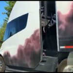 Tesla Semi truck with cowboy graffiti art painted on the trailer and the truck at Cyber Rodeo, spotted at a California highway.