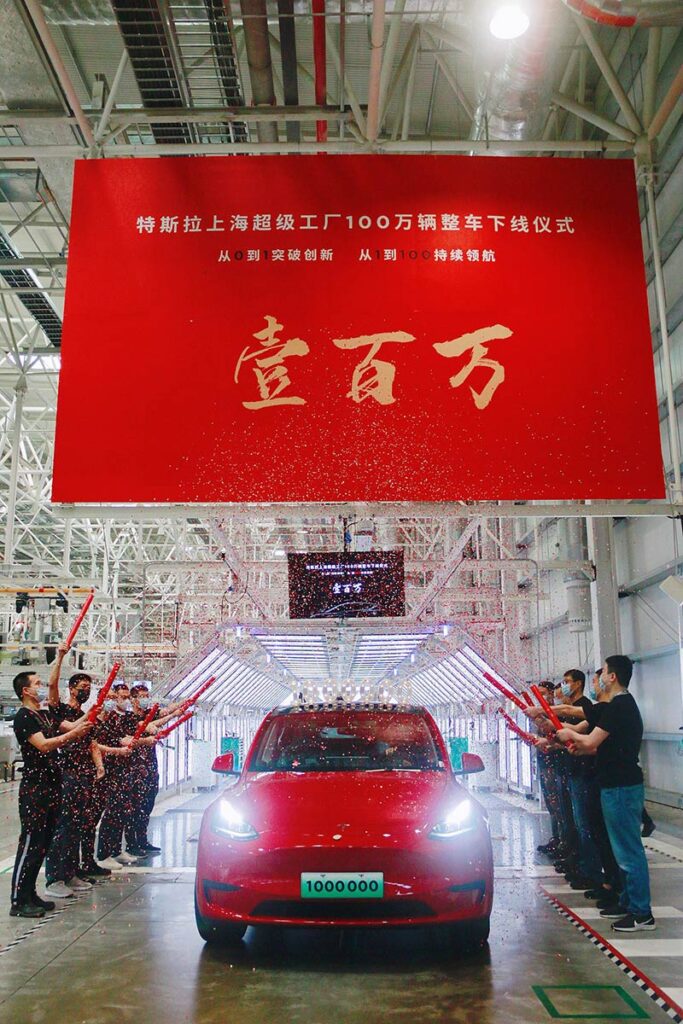 Giga Shanghai employees celebrate the production of the 1 millionth vehicle produced at the factory (a red Tesla Model Y). Credit: Tesla China via Jay in Shanghai / Twitter.