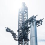 Starship crane Mechazilla lifts the Super Heavy Booster 7 rocket to mount it on the launch pad at SpaceX Starbase Boca Chica,