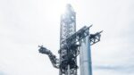 Starship crane Mechazilla lifts the Super Heavy Booster 7 rocket to mount it on the launch pad at SpaceX Starbase Boca Chica,