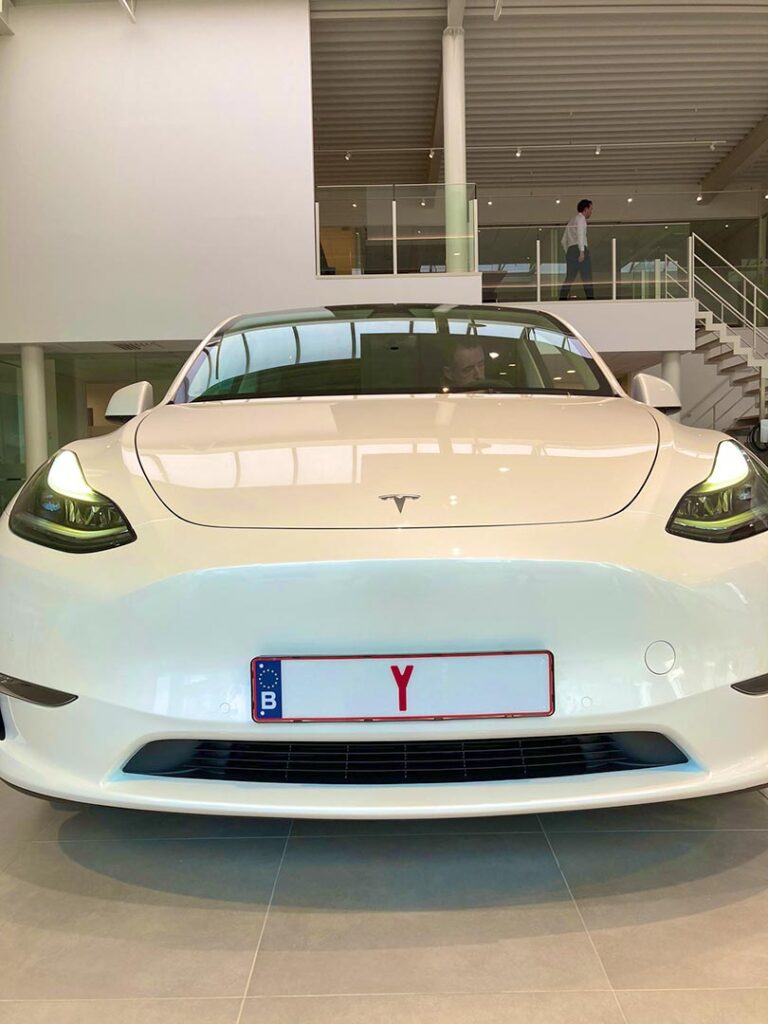 A white Tesla Model Y on display at the Brugge Tesla Store opening ceremony in Belgium.