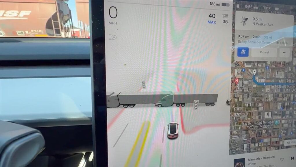 Tesla Vision renders cargo train bogies as semi trucks on the center display of the car.
