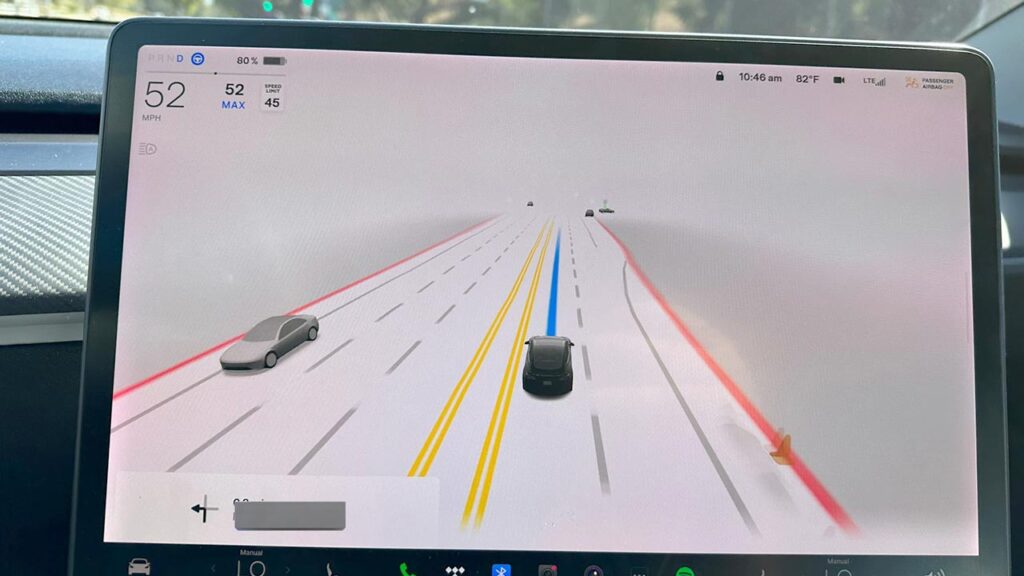 Tesla driving visualizations of FSD Beta 1069.2.3 on the center touchscreen of a Model 3 EV.