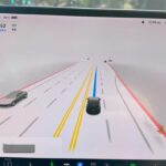 Tesla driving visualizations of FSD Beta 1069.2.3 on the center touchscreen of a Model 3 EV.