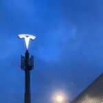 Tesla logo installed on a high tower at a Tesla Store and Service Center in the Netherlands.