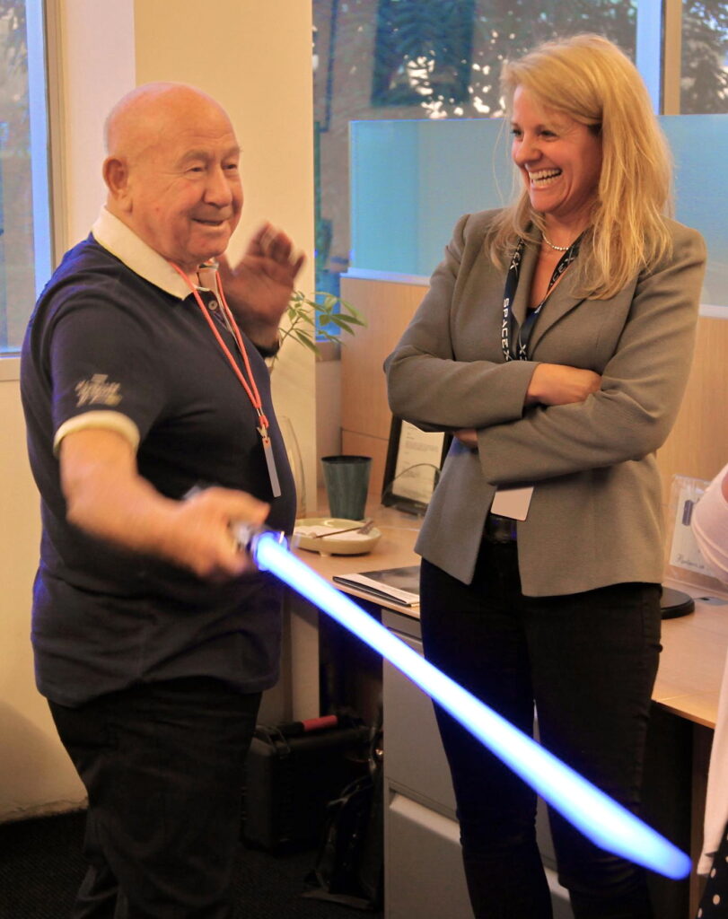 The 1st person to walk in space Alexey Leonov (left) shows lightsaber skills to SpaceX President Gwynne Shotwell (right) at the SpaceX HQ in 2012.