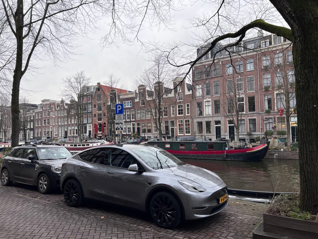 Tesla Model Y in Quicksilver color parked outside in the outdoors in Europe.