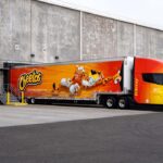 FritoLay's Tesla Semi truck colored in Cheetos/Frito-Lay branding that PepsiCo is using for logistics in the United States.