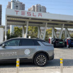 Cadillac parks a LYRIQ electric SUV at a Tesla Supercharger in China offering free test drives to Tesla owners.