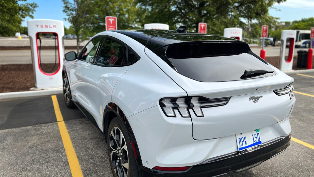 A Ford Mustang Mach-E electric SUV charging at a Tesla Supercharger (file photo).