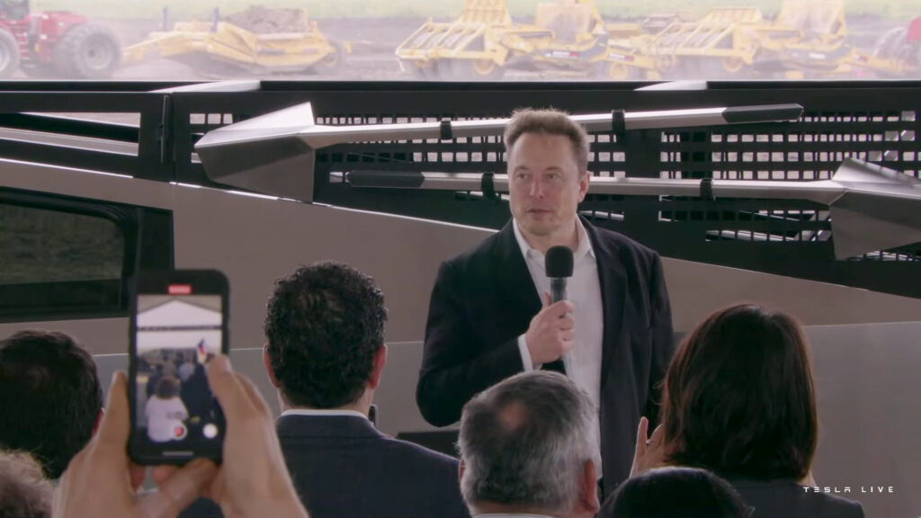 Custom-designed shovels can be seen attached to the Cybertruck side rails grill while Tesla CEO Elon Musk addresses the Tesla Lithium refinery's groundbreaking ceremony in Corpus Christie, Texas. 