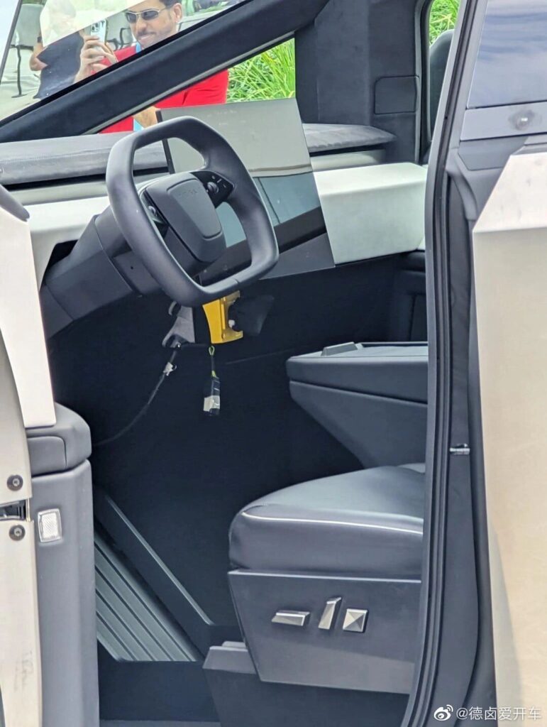 A glimpse of the Cybertruck front seat, steering wheel, dashboard , and the interior from the 2023 Tesla Shareholder Meeting.