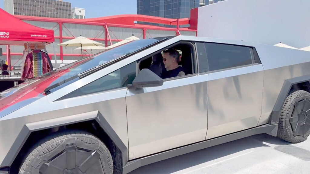 Tesla Chief Designer riding the Cybertruck with the front window all the way down.