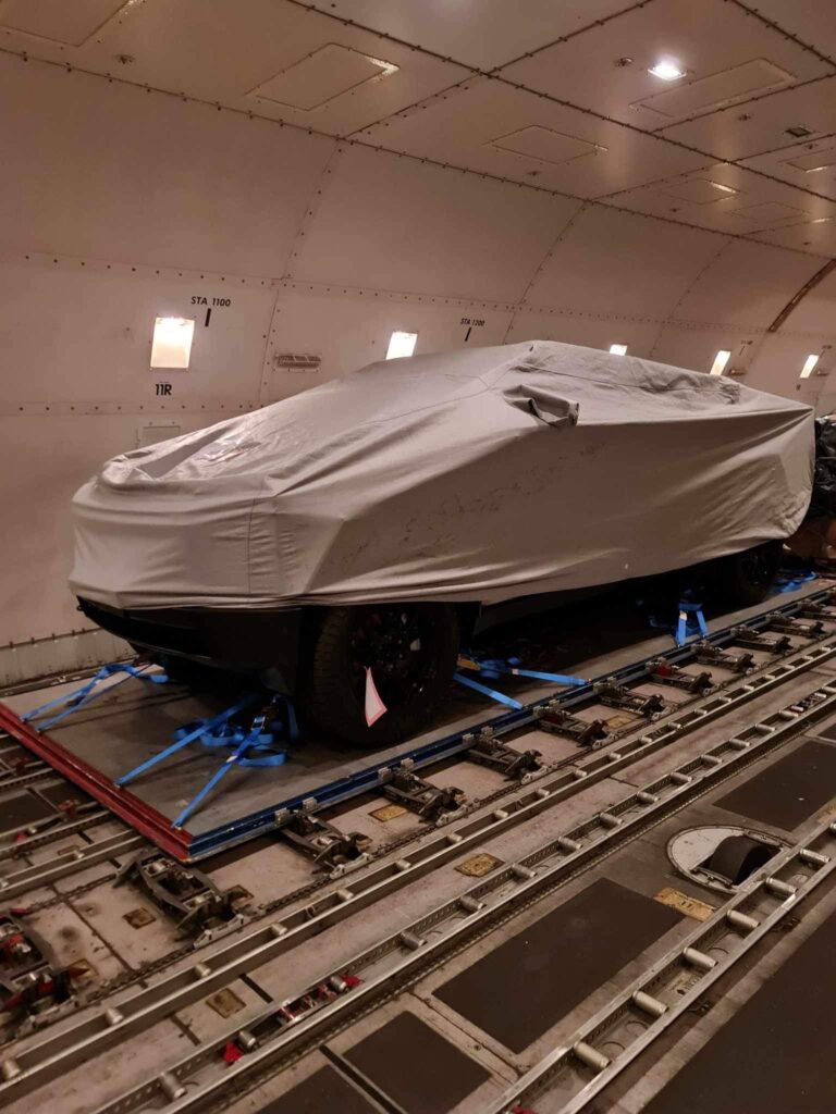 A covered Cybertruck prototype leaving Singapore for Auckland, New Zealand on a car carrier vessel.