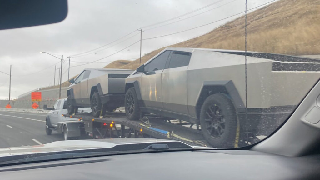 Two Cybertruck prototypes loaded on a car carrier trailer spotted on a California freeway.