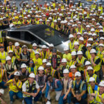 Tesla engineers and workers gather around the first-ever production Cybertruck for a group selfie at Giga Texas.