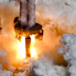SpaceX performing a 33-engine static fire test on Super Heavy Booster 9 at Starbase, Texas on Friday 25th August 2023. The collision of the Raptor engine fire and water from the OLM deluge system created large clouds of mist and vapors.