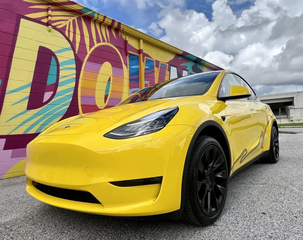 DASH rideshare Tesla Model Y wrapped in yellow  color.