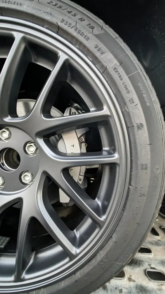 A closeup of the 18" tire and wheel of the new Tesla Model 3 Highland. 18" wheel installed with Michelin e-Primacy 235/40R18 tire.