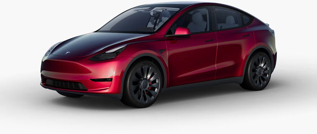 A Tesla Model Y wrapped in the OEM Crimson Red color wrap.
